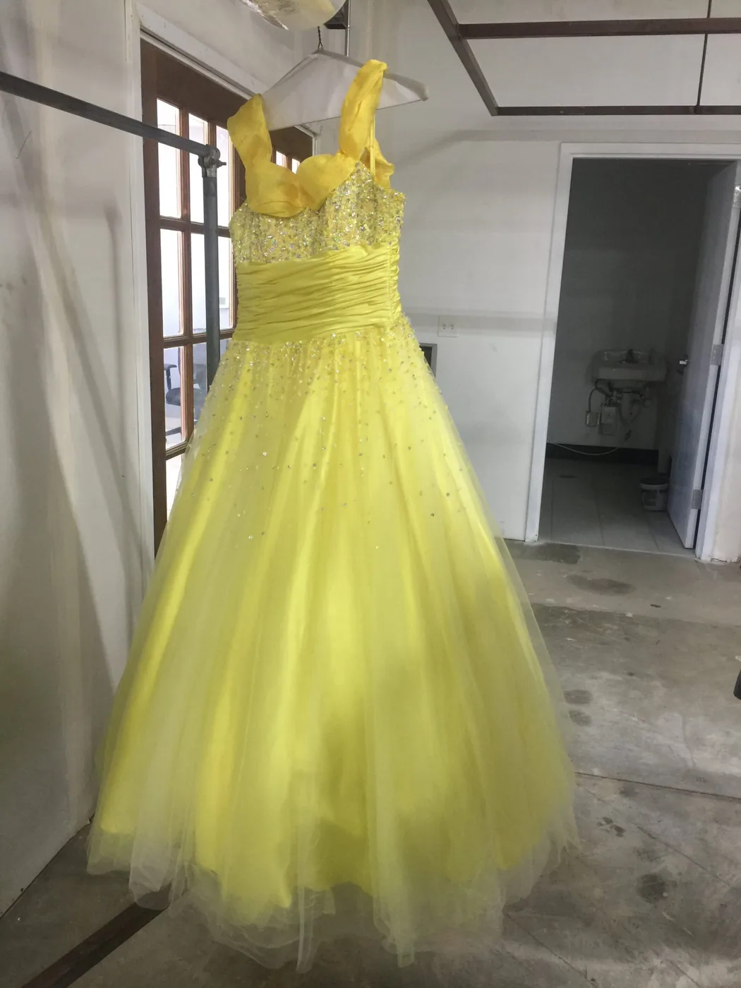 Yellow formal gown after cleaning and pressing