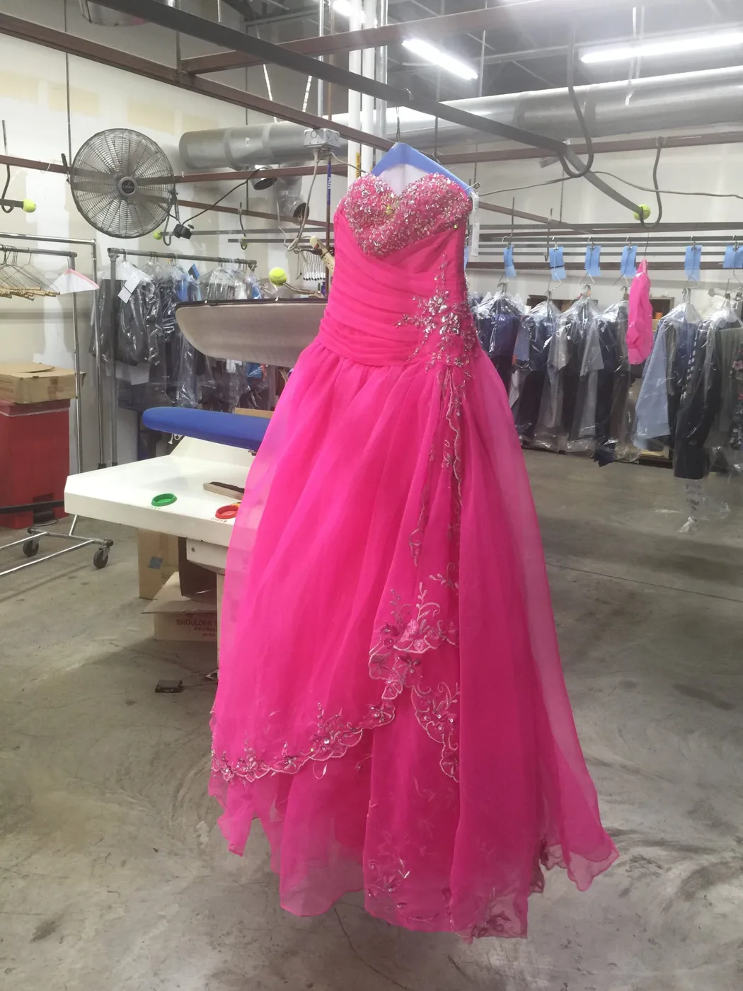 Fuchsia quinceañera dress on the finishing table