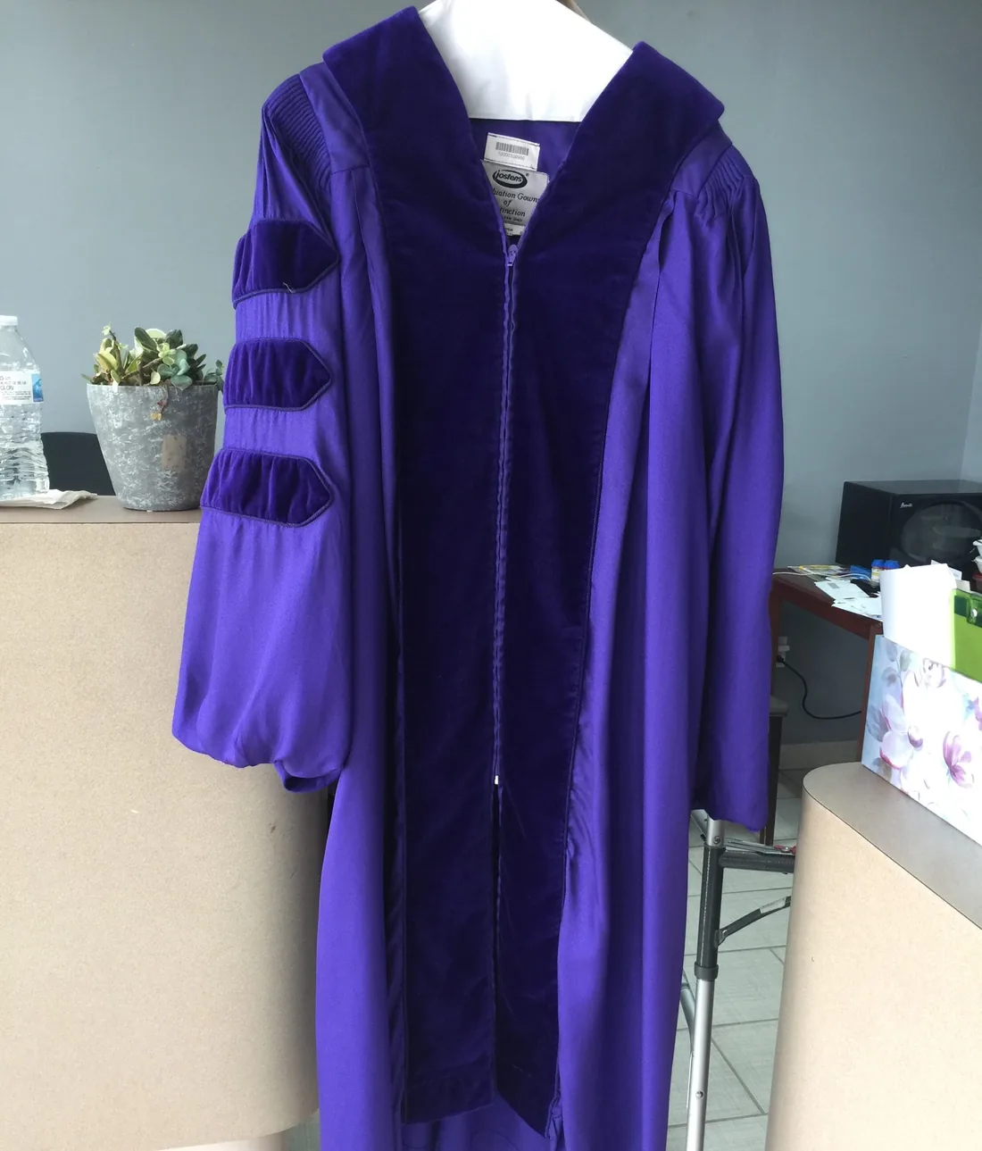 Purple academic doctoral gown pressed and hung